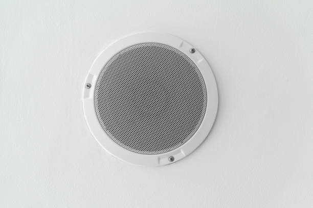 istock White round circle speaker and grille hanging on white ceiling 855663818