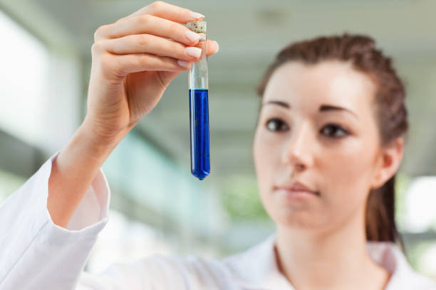 istock Brunette scientist looking at a test tube 855666672