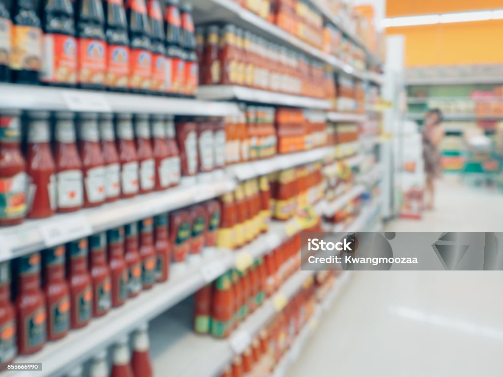 ketchup sauce seasoning bottles products in supermarket shelves blurred background Ketchup Stock Photo