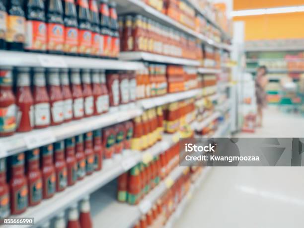 Ketchup Sauce Seasoning Bottles Products In Supermarket Shelves Blurred Background Stock Photo - Download Image Now