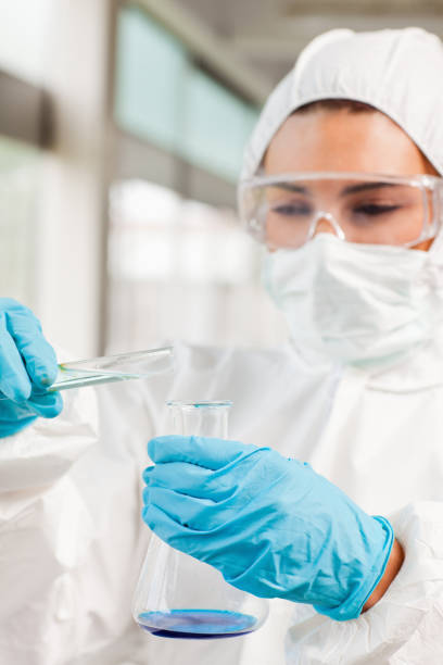 istock Portrait of a protected scientist pouring liquid 855667356