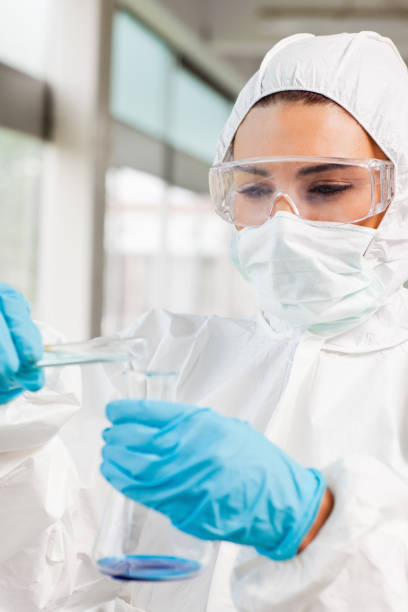 istock Portrait of a protected female scientist pouring liquid 855667368
