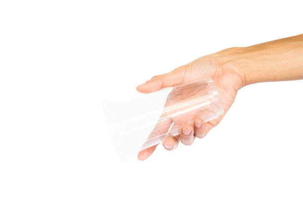 istock Hand holding plastic cup like a pouring isolated on white background with clipping path. 855670446