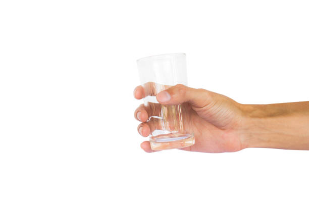 istock Hand holding empty glass isolated on white background with clipping path. 855670448