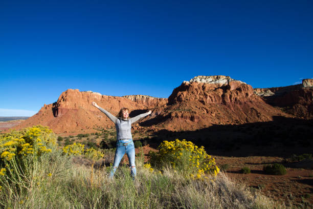 istock Wilderness Victory: Woman with Arms Raised in Joy 855674626