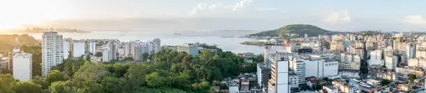 Panoramic photograph of downtown Niteroi (Centro de Niterói) viewed from a high angle - drone like view. Guanabara bay and Rio-Niterói bridge and Rio de Janeiro downtown on the background with muitiple buildings.