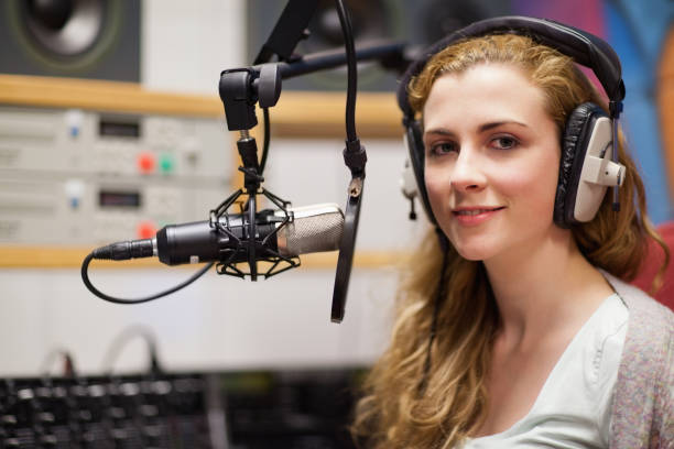 istock Young woman posing with a microphone 855677930