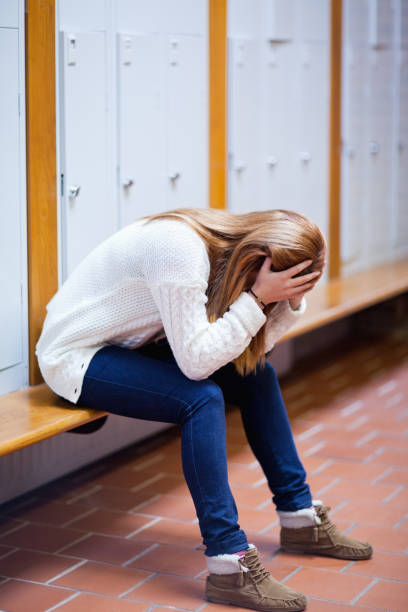 istock Portrait of a depressed student sitting on a bench 855680340