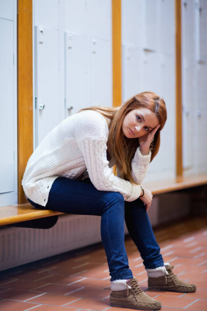 istock Portrait of a sad student sitting on a bench 855680346
