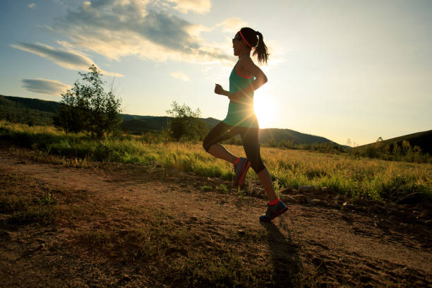 istock trail runner woman running on forest trail 855680692