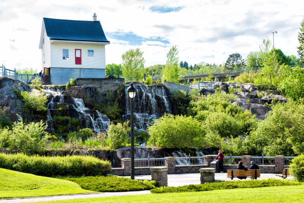 chicoutimi park in quebec mit fluss und wasser fließt im sommer und menschen - chicoutimi travel locations nature city stock-fotos und bilder