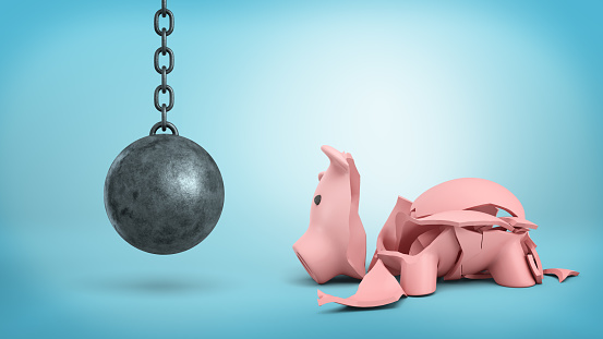 3d rendering of a resting wrecking ball on a chain hangs near a cracked piggy bank on blue background. Loss of income. Banking crisis. Investment trouble.