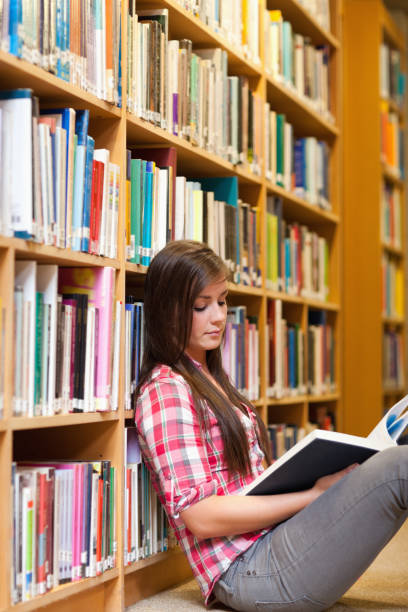 istock Portrait of a young female student reading a book 855695388