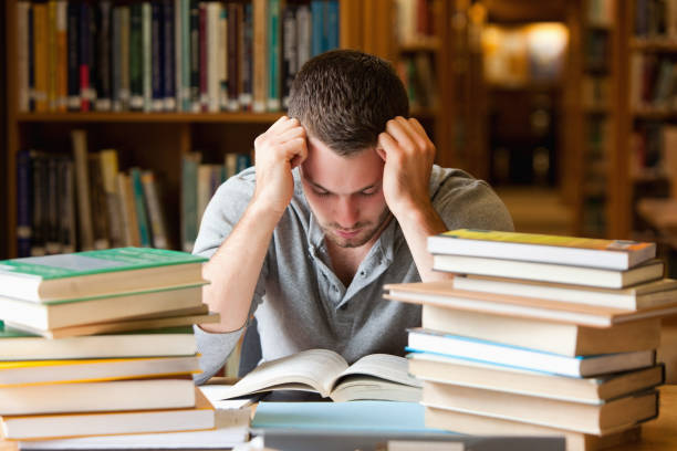 istock Tired student having a lot to read 855697814