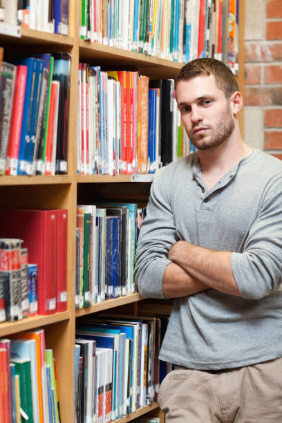 istock Portrait of a male student leaning on a shelf 855697930