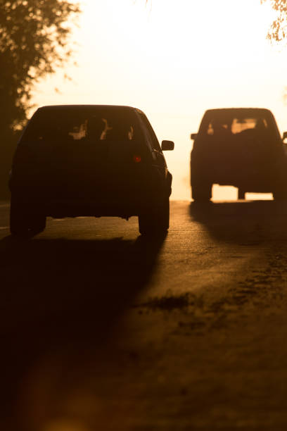 istock car rides on the road at sunset 855699576