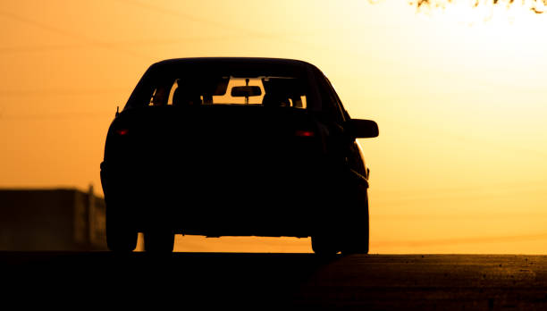 istock car rides on the road at sunset 855699720