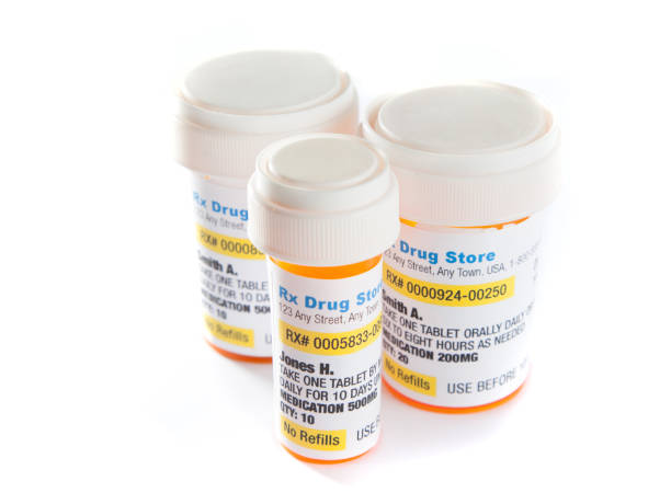 Medicine Bottles of perscrption medicine on white +++ all labels are fictitious and printed by photographer - copyright free ++  totally made up pill bottle photos stock pictures, royalty-free photos & images