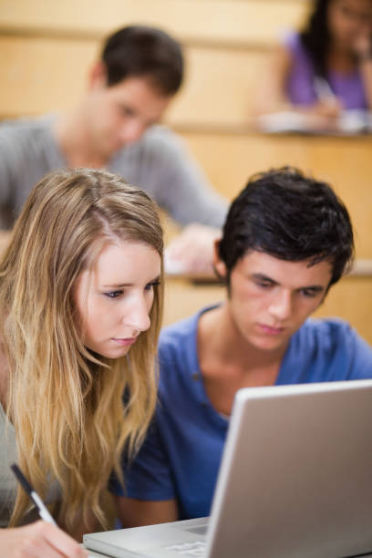 istock Portrait of students working with a laptop 855711406