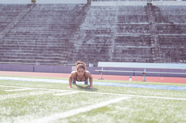 istock Female athlete working out at stadium field 855711548