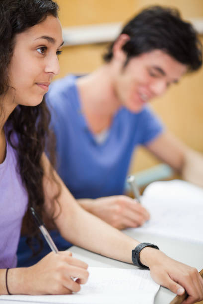 istock Portrait of smiling students writing 855711668