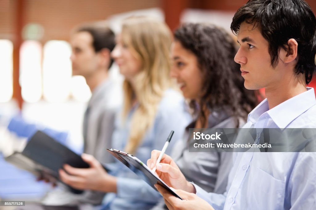 Business people taking notes Business people taking notes during a presentation 18-19 Years Stock Photo