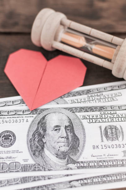 heart, sandglass & banknotes: concept for love, money & time - close up one dollar bill history finance imagens e fotografias de stock