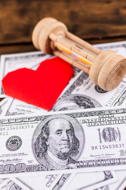 heart, sandglass & banknotes: concept for love, money & time - close up one dollar bill history finance imagens e fotografias de stock