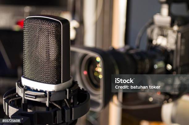 Retro Microphone On Stage A Background Of Studio Camera Stock Photo - Download Image Now