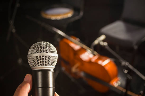 istock Audio microphone and blur musical instrument background 855725680