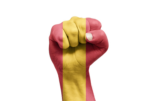 Spanish flag painted on hand with fist shape. Referendum. Isolated white background