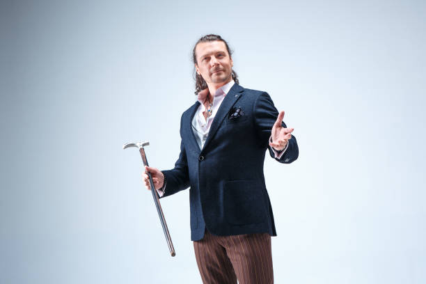 istock The mature barded man in a suit holding cane 855741634