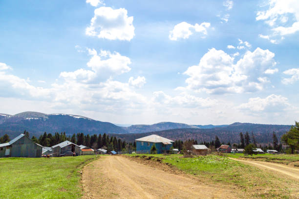 View of Sakarca Plateau with large meadow area and mountain houses around on cloudy sky background.