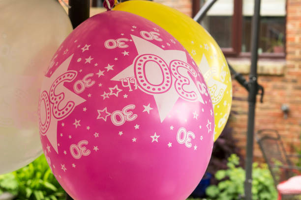 istock pink and yellow 30th birthday ballons 855744802