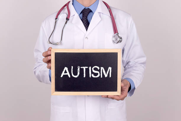 istock Doctor holding mini blackboard with AUTISM message 855745840