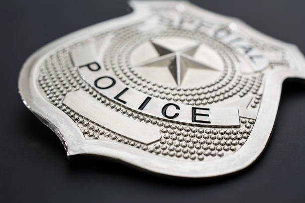 istock Police badge close-up on black background 855752550