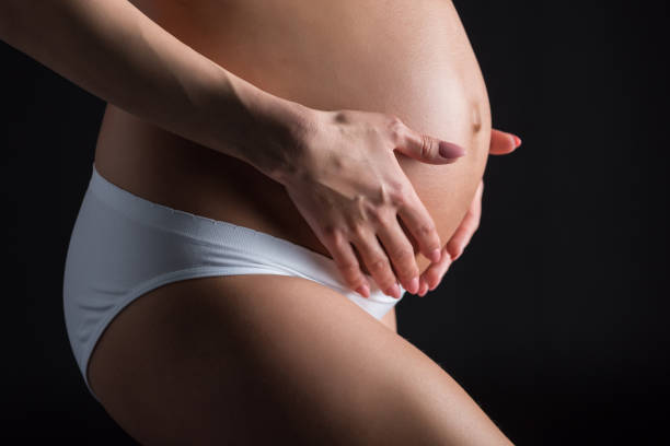 istock pregnant woman touching belly 855752608