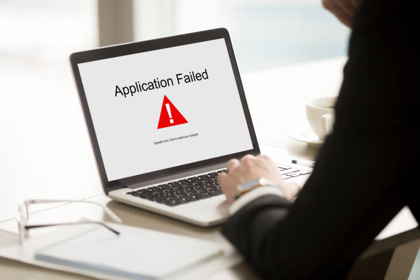 Application failed, businessman having problem with laptop, soft Application failed, businessman having problem with laptop, bad software failure on screen, broken computer stopped working in office, hanging pc caused system crash error message, close up rear view error message stock pictures, royalty-free photos & images