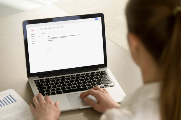 istock Businesswoman typing corporate e-mail using laptop at office des 855752984