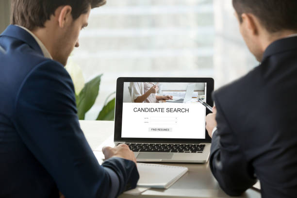 istock Two employers looking for professional staff online, closeup rea 855753026
