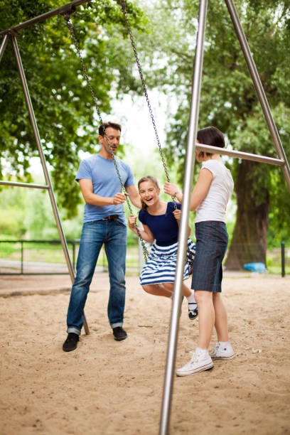 istock Family playing in park 855755632