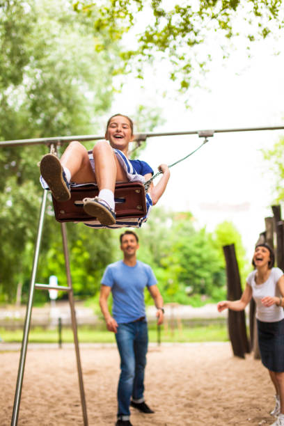 Father and daughter playing in park together, Berlin lypse