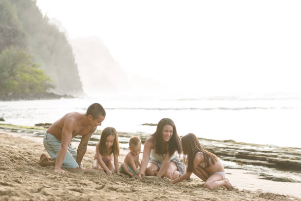 istock Hawaii family plays on sandy beach together 855758648