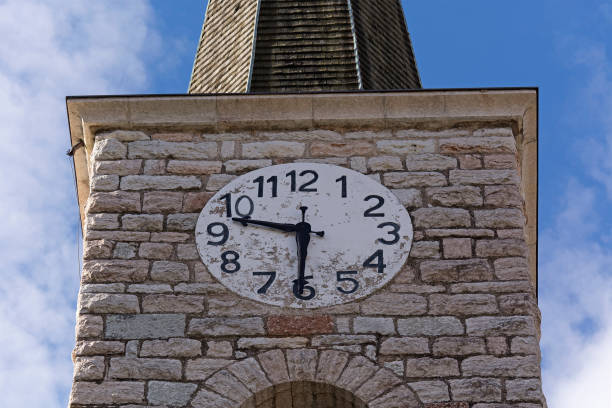 Simple clock on church tower in Coredo, Val di Non, Italy