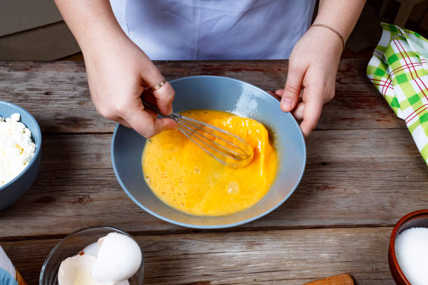 cooking food. woman cook breaks egg dough. - chef cookie dishware domestic kitchen imagens e fotografias de stock