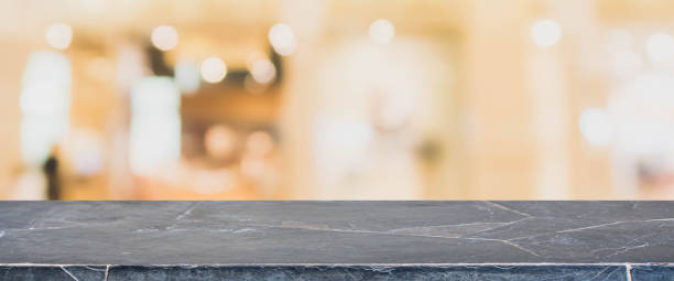 istock Black stone marble table top and blurred abstract background from interior building banner background - can used for display or montage your products. 855768038
