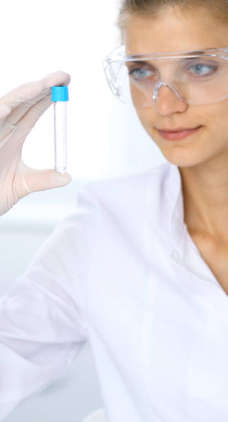 female scientific researcher in laboratory studying substances or blood sample. medicine and science concept - close up medical test exam people imagens e fotografias de stock