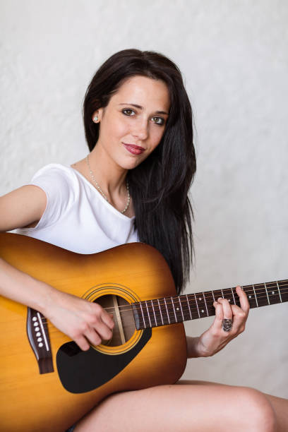 istock Woman playing Guitar 855774666
