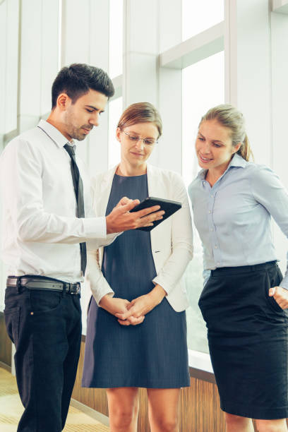istock Smiling business team looking at digital tablet 855775580