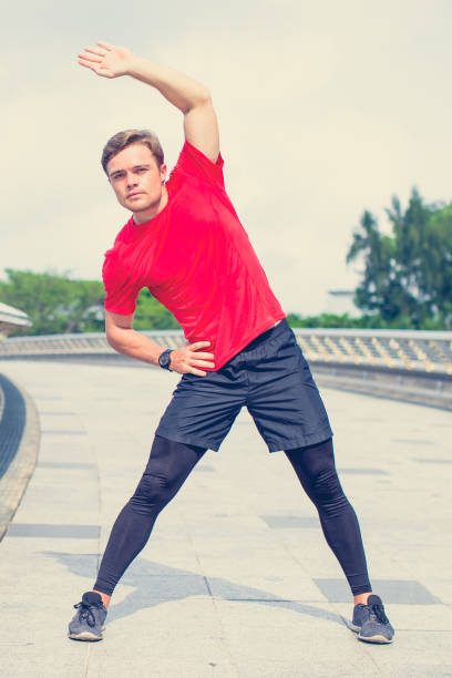 istock Sporty Young Man Doing Side Bends Outdoors 855775914